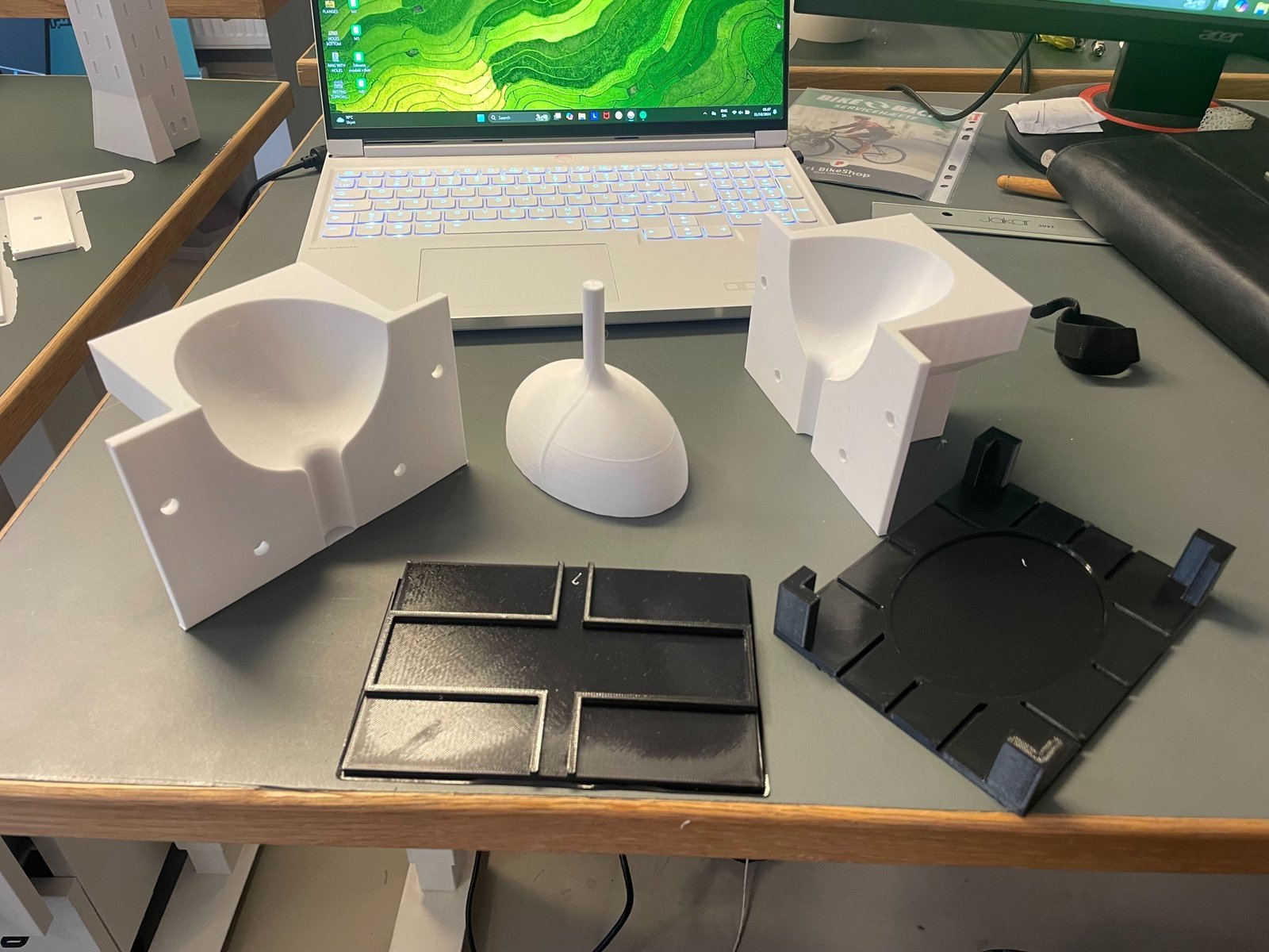 Two-part 3D printed molds and a cast part on the workbench